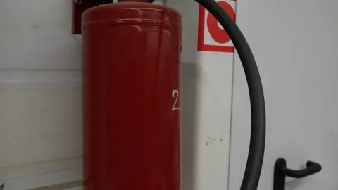 Close up of wall mounted fire alarm and Fire Extinguisher. Red fire extinguisher Stock Footage 303576483