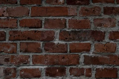 Close-up of wall with red bricks and concrete. Abstract background texture. Stock Photos