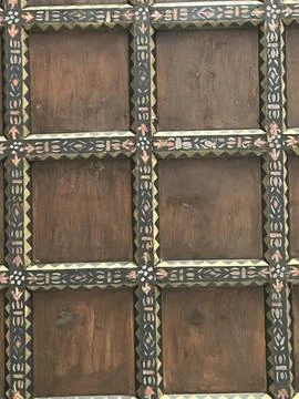 A close up of a wall with square patterns, possibly made of wood or brickwork Stock Photos