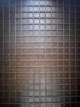 A close up of a wall with square patterns, possibly made of wood or brickwork Stock Photos