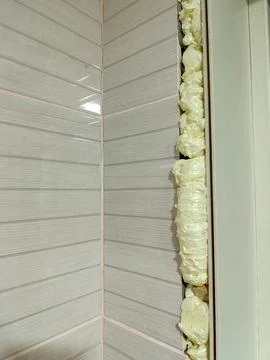 A close up of a wall with a white tiled wall behind it Stock Photos