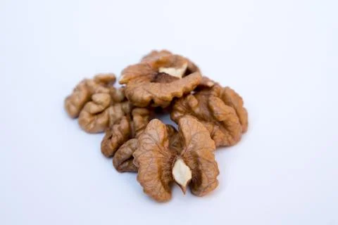 Close-up of walnut kernels on white background Stock Photos