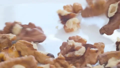 Close-up of a walnut shell on white surface, surrounded by cloud and sky. Stock Footage 264071972