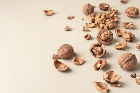 Close-up of walnuts and shells on neutral background. Natural healthy food co Stock Photos