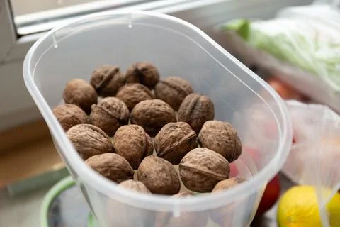 Close up of walnuts on a kitchen table in a container Fotos de archivo