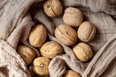 Close-up of walnuts on rustic fabric. Stock Photos