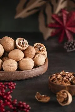 Close-up walnuts in shell and chopped walnuts. Stock Photos