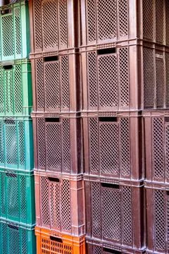 Close-up of a warehouse of empty plastic boxes. Stock Photos