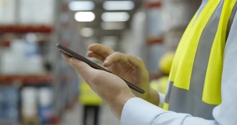 Close up of warehouse worker using mobile phone at workplace Stock Footage 151404243