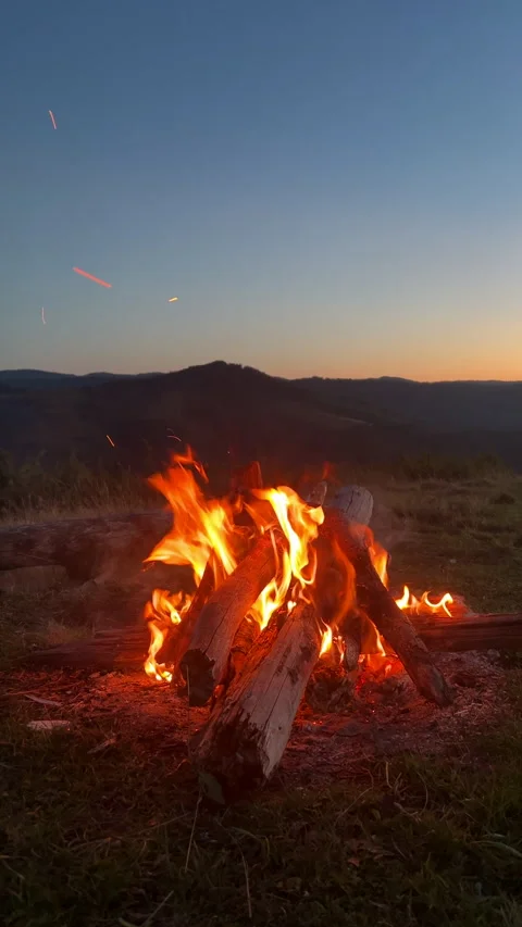 Close up of warm campfire on background mountains at night Stock Footage 323768802