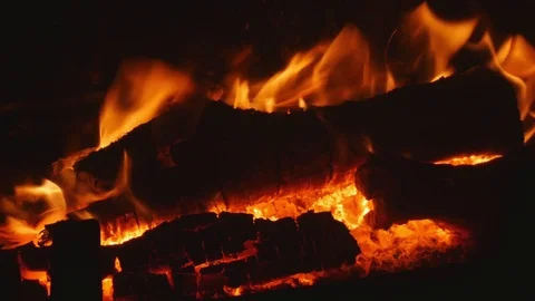 Close up of a warm log fire in a fireplace on a winter day Stock Footage 81630497