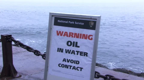 Close-up of warning sign at oil-polluted beach Stock Footage 59543501