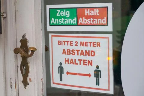 Close up warning sticker of 2 meter social distancing and push/pull on the door Stock Photos