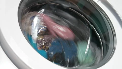 Close-up of washable clothes in the drum of a washing machine Stock Footage 276710218
