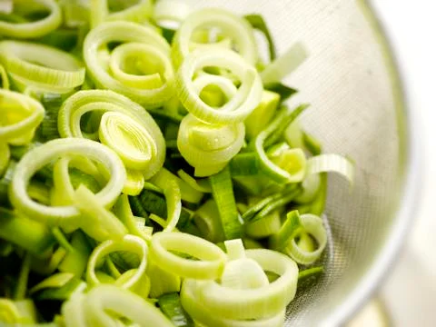 Close up of washed chopped leeks in a sieve Stock Photos