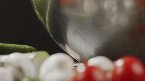 Close-up of washed metal cherry tomatoes from metal bowl with water Stock Footage 124066501