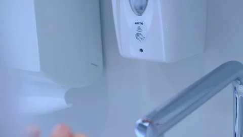 Close up washing hands with an automatic alcohol sanitizer dispenser Stock Footage 137311762