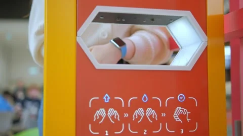 Close up washing hands with an automatic alcohol sanitizer dispenser at mall Stock Footage 233502153
