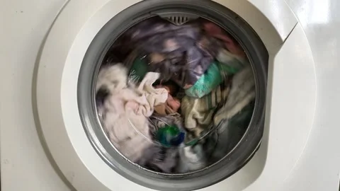 Close up of washing machine drum with rotating laundry and detergent capsule. Stock Footage 335885344