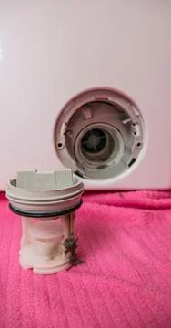 Close-up of a washing machine filter cleaning, with the dirt clearly visible Stock Photos