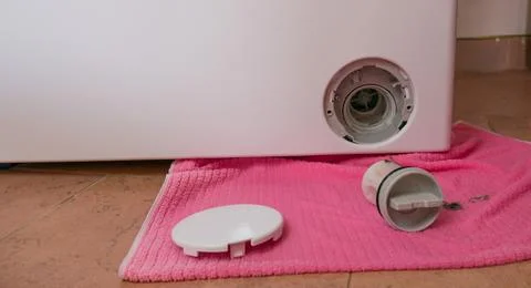 Close-up of a washing machine filter cleaning, with the dirt clearly visible Stock Photos