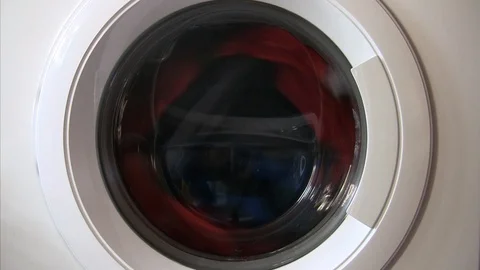 Close up of a washing machine porthole at work Stock Footage 103264323