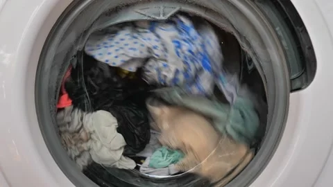 Close-up of washing machine in the process, wash clothes in the washing machine. Stock Footage 258243284