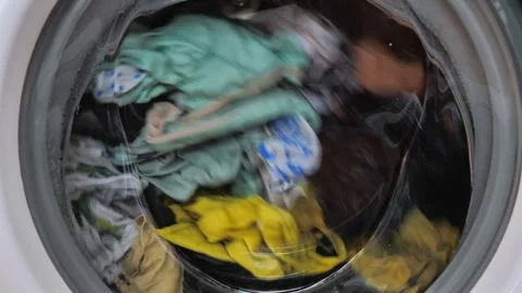 Close-up of washing machine in the process, wash clothes in the washing machine Video stock 258250883