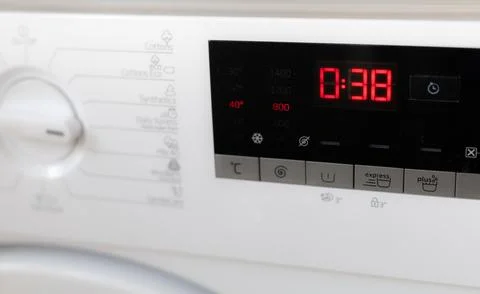 Close-up of a washing machine's control panel displaying the remaining time.. Stock Photos