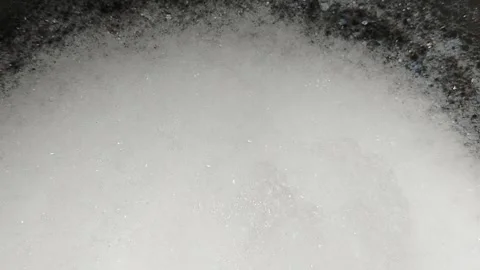 Close-up of washing soap foam inside a plastic bucket, featuring detergent  库存影片 336163973
