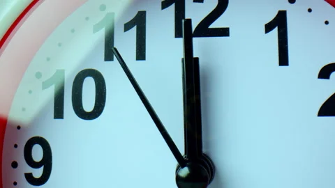 Close-up of the watch face with large numbers. A red-edged clock indicates Video stock 166104271