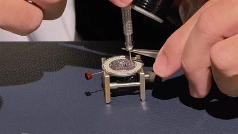 Close-up watchmaker's hands making watch timepiece Stock Footage 317021645