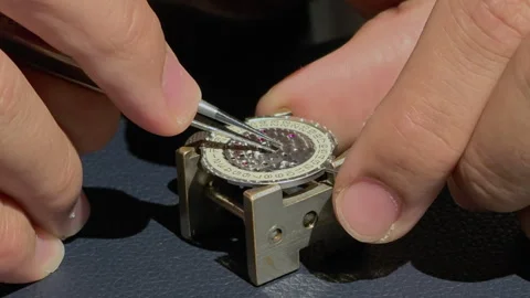 Close-up watchmaker's hands making watch timepiece Stock Footage 317022095