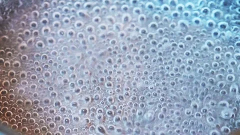 Close up of water boiling with bubbles Stock Footage 318297837