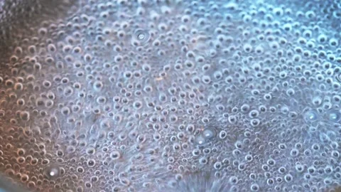 Close up of water boiling with bubbles Stock Footage 318297873