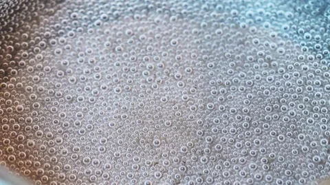Close up of water boiling with bubbles Stock Footage 318297908
