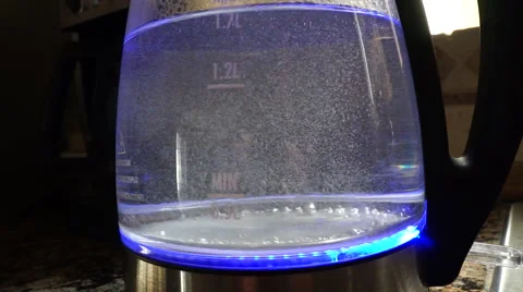 Close up of water boiling in a clear see through LED tea kettle Stock Footage 47331328