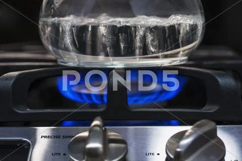 Close-up of water boiling on gas burner Stock Photos