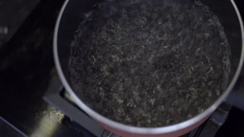 Close up water boiling on pan Stock Footage