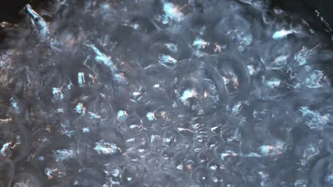 Close-up of water boiling with rising bubbles Stock Footage 318297951