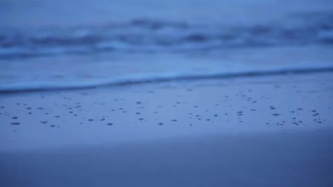 CLOSE UP OF WATER BREAKING ON SHORE Stock Footage 253909764