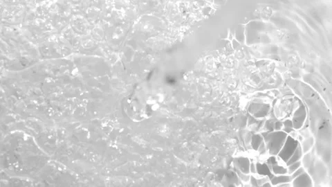 Close-up of water bubbles and shimmering light reflections on a smooth surface Stock Footage 315675592