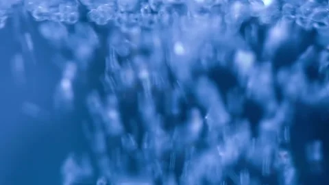 Close-up water bubbling or boiling in clear glass. on a black background. Video stock 283067489