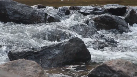 Close up water cascade flowing over rock in a river 動画素材 104309504