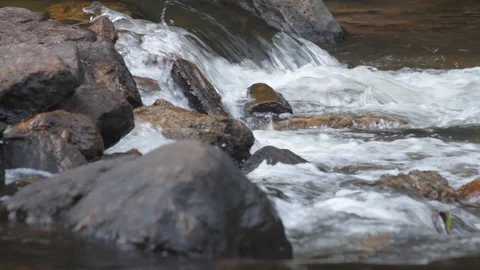 Close up water cascade flowing over rock in a river 動画素材 104309514