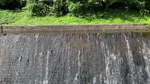 Close-up of water cascading down the concrete surface of the Ems river weir.. Stock Footage 340071545