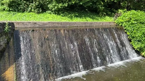 Close-up of water cascading down the concrete surface of the Ems river weir.. Stock Footage 340071554