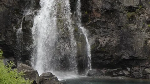Close Up of Water Cascading Down Rugged Basalt Cliffs in Iceland 4K Nature Stock Footage 339737593