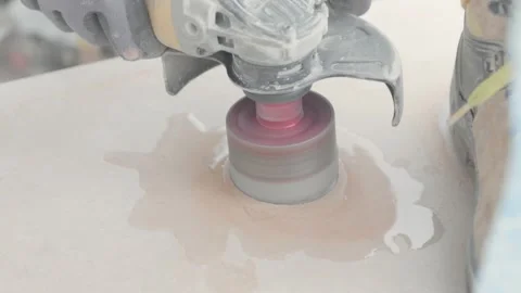 Close up of a water cutting with a circular power tool. Tiler cutting holes in Stock Footage 344059267