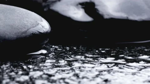 Close-up of water dripping onto stone Stock Footage 234475260